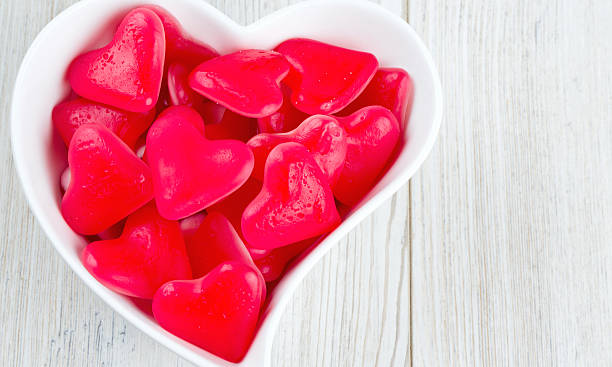 istock heart-shaped candies in a bowl on wooden surface 618749384