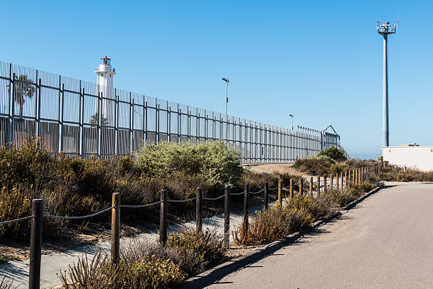 Border Fence with Lighthouse and Security Tower stock photo