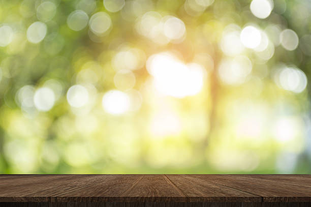 istock Wood table on shiny sunlight bokeh background. 618760284