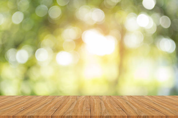 istock Wood table on shiny sunlight bokeh background. 618760308