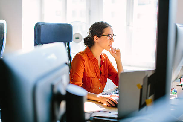 mujer de negocios trabajando en su escritorio - fundador fotografías e imágenes de stock