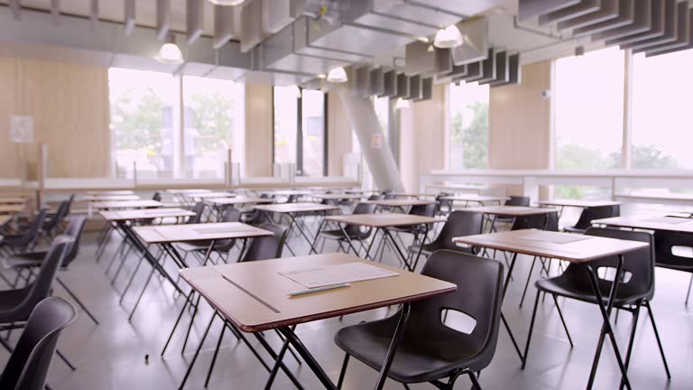 Tests on desks in empty classroom