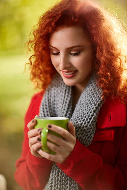 istock Female with cup of tea in nature 618829952