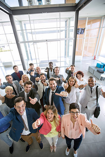 istock success smiling business group giving thumbs up 618830766