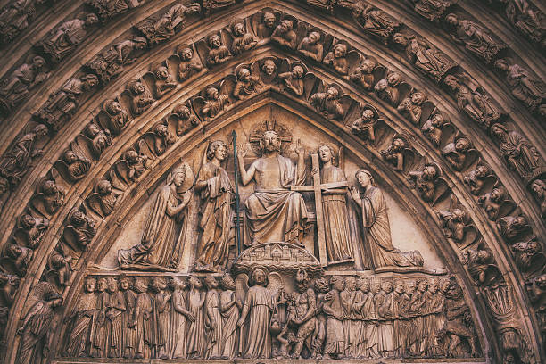 Detail of the art above the Portal of the Last Judgement (built in 1220s-1230s), the center portal of the Notre Dame Cathedral in Paris. In the center, Christ is seated on his throne.