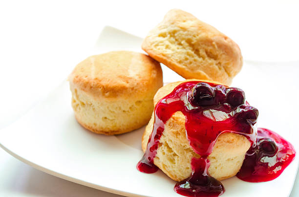 istock Scones with blueberry sauce on white plate. 618832806