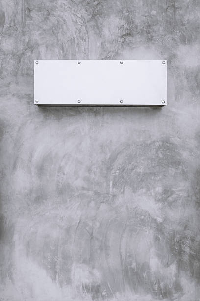 istock metal sign wite bare concrete wall. 618832886