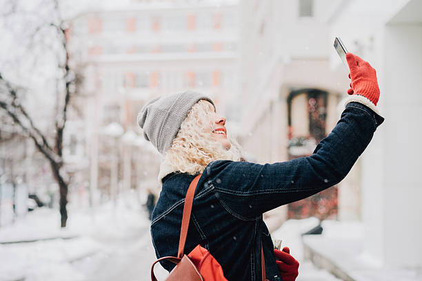istock Young blond curly girl making selfie 618833994