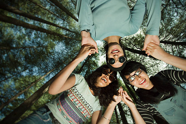istock Low angle view of happy girls holding hands, making circle. 618834902