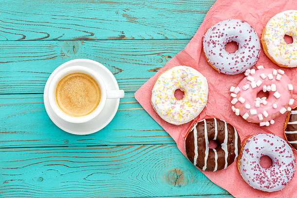 istock Donuts on colorful wooden background 618835678