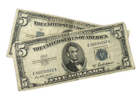Two old 5 dollar silver certificates in used condition on white background.