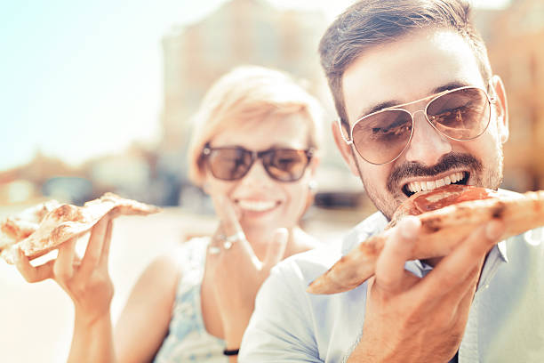 istock Young couple eating pizza 618837228