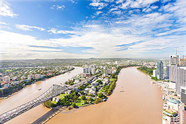 istock Riverside bridge with buildings and green gardens. 618838308