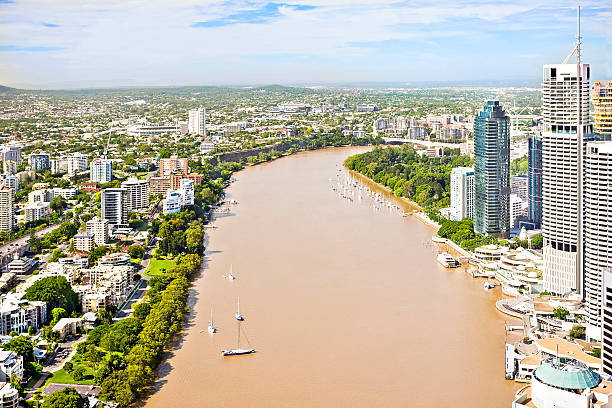 istock Riverside town with buildings and green gardens. 618838800