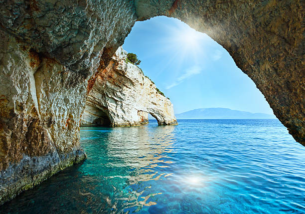 The Blue Caves in Zakynthos (Greece) Sunshine in Blue Cave arch view from boat (Zakynthos, Greece, Cape Skinari ) zakynthos stock pictures, royalty-free photos & images