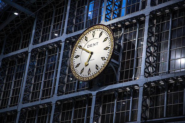 London, UK - October 2, 2016:  Dent clock at St. Pancras railway international station. The clock overlooks the controversial statue, \
