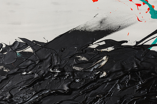 Abstract texture of black acrylic paint on a white canvas