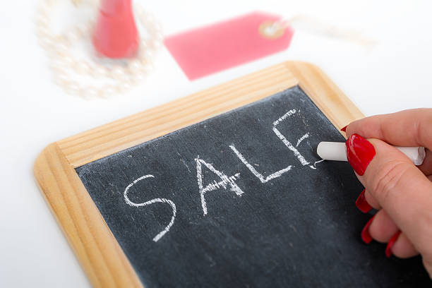 istock Woman writes sale on slate tablet 618842130