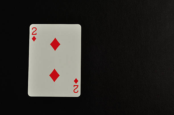 istock Playing card. Two of diamond isolated on a black background 618843764