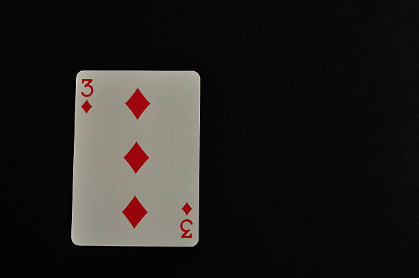istock Playing card. Three of diamond isolated on a black background 618843832