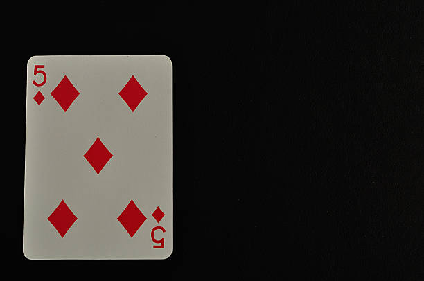 istock Playing card. Five of diamond isolated on a black background 618844016