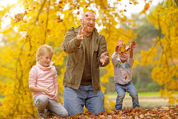 Single father and daughters playing together in autumnal park surroundings Single father and daughters playing together in autumnal park surroundings divorcee stock pictures, royalty-free photos & images