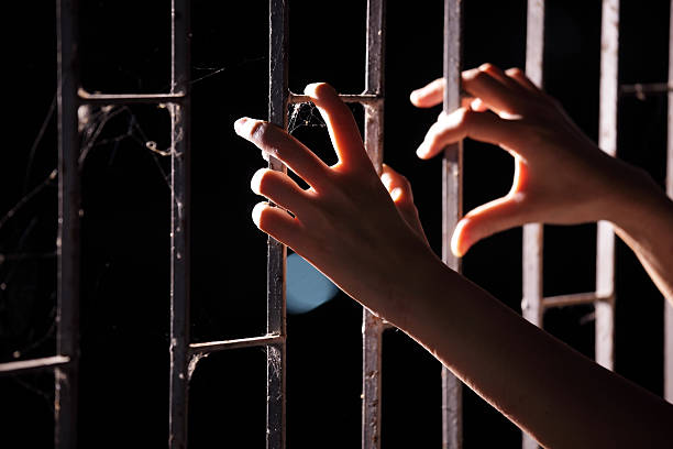 istock hands of prisoner in jail 618846080