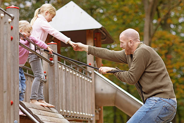 Single father and daughters playing together in autumnal park surroundings Single father and daughters playing together in autumnal park surroundings divorcee stock pictures, royalty-free photos & images