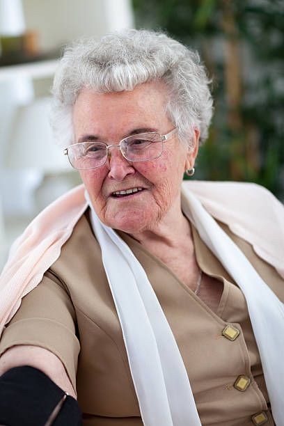 istock Old woman measuring her blood pressure 618848022