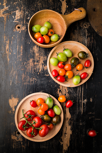 Fresh Colorful tomatoes on wooden table