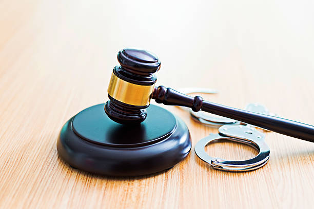 istock Gavel and handcuffs on desk 618848172