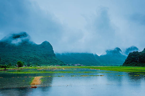 istock Karst mountains and rural scenery in the mist 618849736