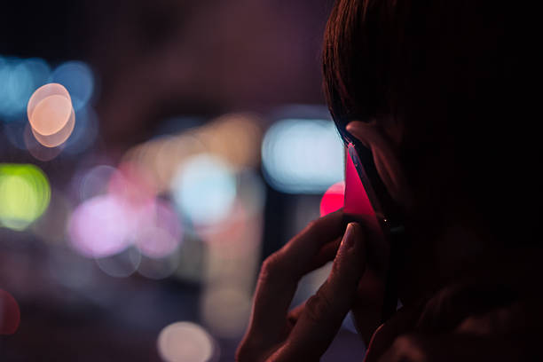 Young man talking on mobile phone at night stock photo