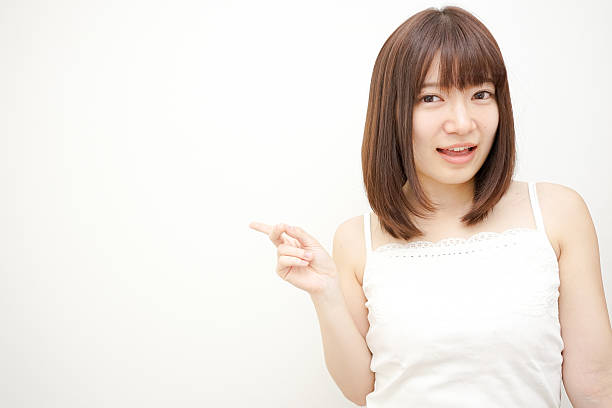 istock Young woman pointing something 618854282