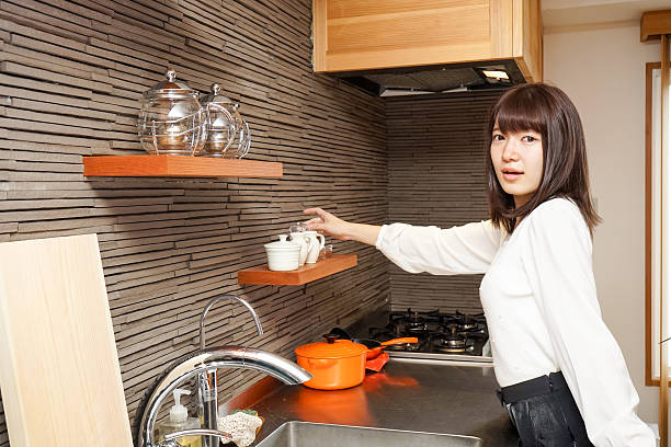 Young woman washing dishes after dinner