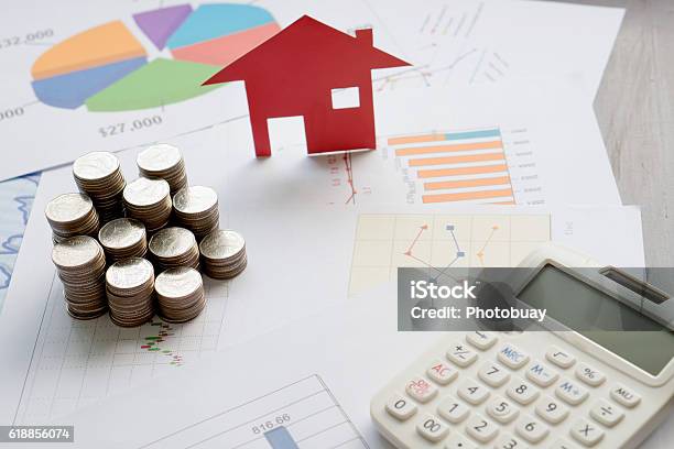 With House Model And Stack Of Coins On Desk Stock Photo - Download Image Now - House, Model - Object, Paper