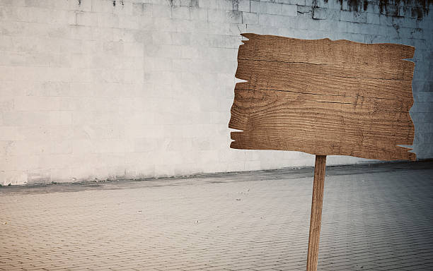 istock Weathered cinder block, brick wall texture, wood sign and walkway 618856406