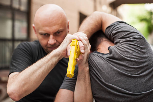 istock Gun Disarm. Self defense techniques against a gun point. 618857288