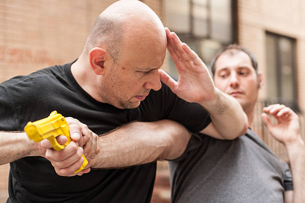 istock Gun Disarm. Self defense techniques against a gun point. 618857672