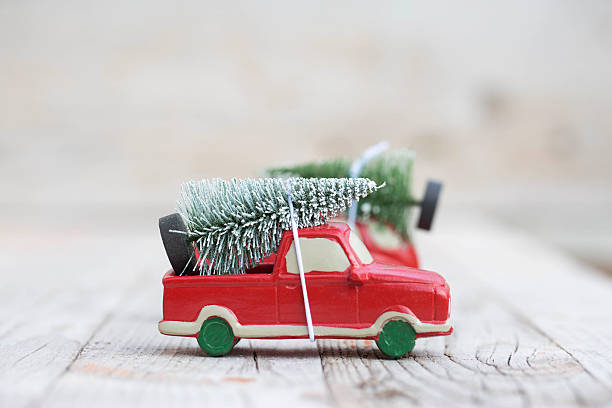 istock Miniature red car with fir tree 618858398