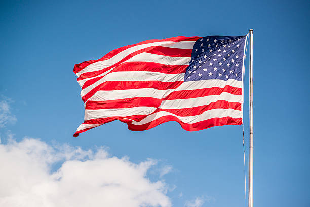 istock American Flag on blue sky 618859308