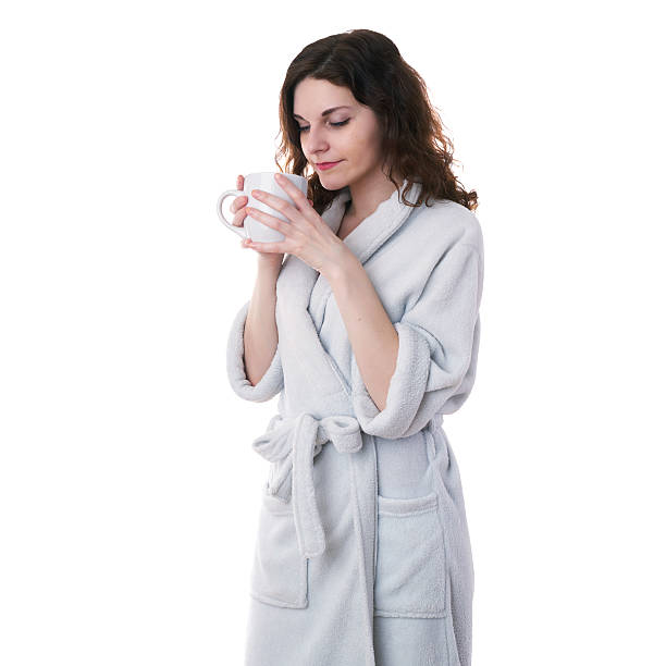 istock Young woman in bath robe over white isolated background 618859754