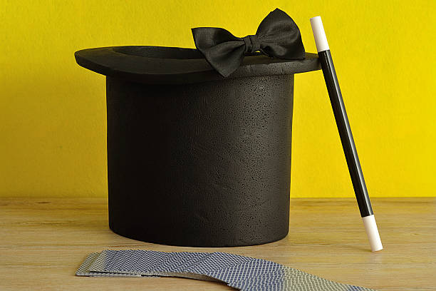 istock Magicians hat , wand, bow tie and a deck of cards 618861374
