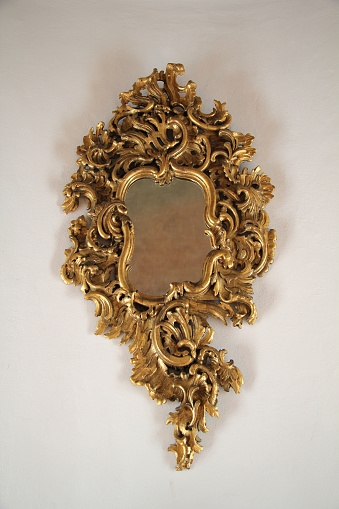 Old golden baroque ornamental mirror