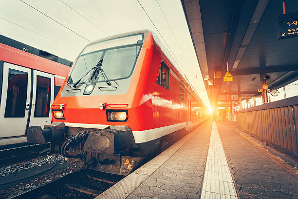 istock Modern high speed red commuter train at colorful sunset 618864224