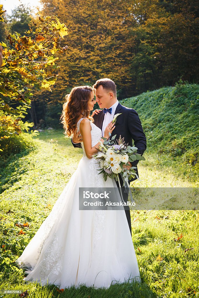 creative stylish wedding ceremony creative stylish wedding ceremony elegant curly bride and groom outdoors on the background the lake Wedding Stock Photo