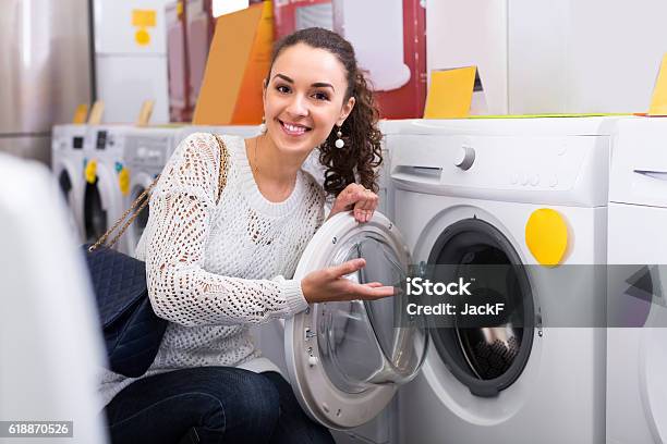 Girl Selecting New Washing Machine Stock Photo - Download Image Now - 20-29 Years, Adult, Agricultural Machinery
