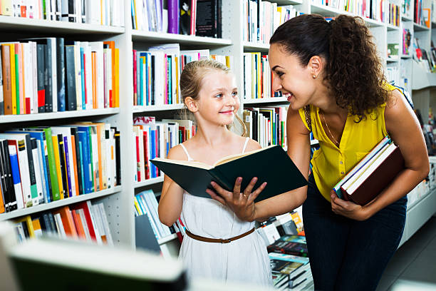 istock Mother with daughter in bookstore 618872660