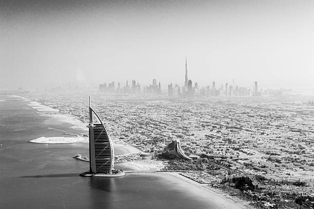 Dubai, United Arab Emirates - October 17, 2014: The famous Burj Al Arab hotel and Dubai skyline taken from a seaplane in black and white
