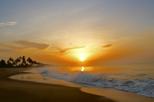 Sunrise over the rolling waves on the beach in rural Ghana.